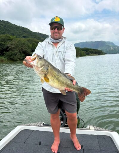 Angler with largemouth bass caught on a Bass Boats 4 Sale day trip