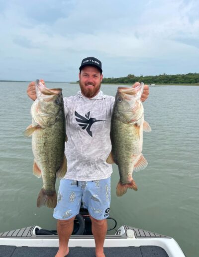 Angler with largemouth bass caught on a Bass Boats 4 Sale day trip