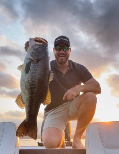 Angler with largemouth bass caught on a Bass Boats 4 Sale day trip