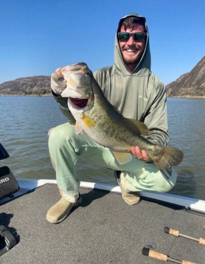Angler with largemouth bass caught on a Bass Boats 4 Sale day trip