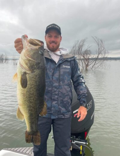 Angler with largemouth bass caught on a Bass Boats 4 Sale day trip